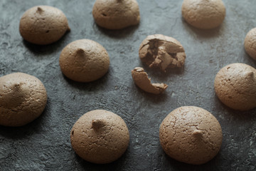 Fototapeta na wymiar chocolate meringue cookies on dark stone table, delicious dessert, selective focus