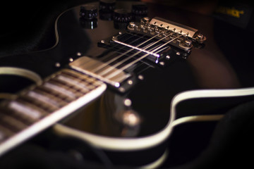 Fototapeta na wymiar Electric guitar close-up on dark background, music studio