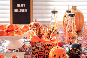 Kid's halloween party table with snacks and cute paper goods