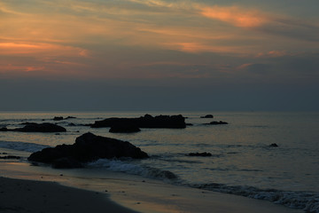 Rocks in the sea and early morning sky