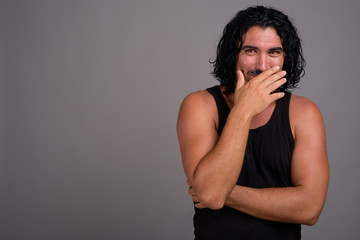 Handsome macho man with mustache against gray background