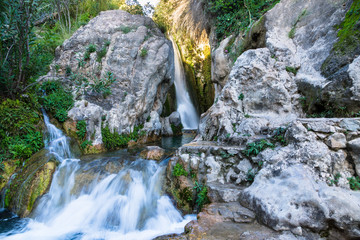 Wonderful waterfall between solid rocks in a natural pond. Fuentes del Algar Costa blanca spain - Alicante Benidorm