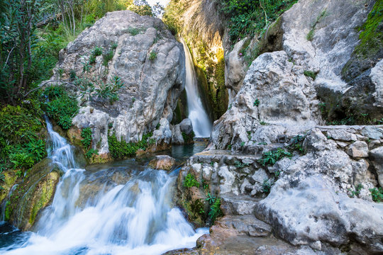 Fototapeta Wonderful waterfall between solid rocks in a natural pond. Fuentes del Algar Costa blanca spain - Alicante Benidorm