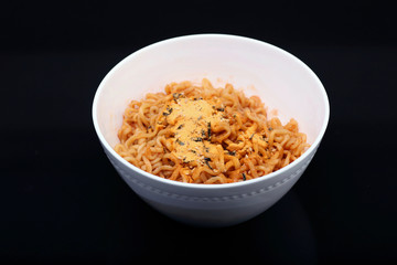 Cheese ramen noodles on black background