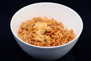 Cheese ramen noodles on black background