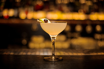 Daiquiri cocktail decorated with lime and berry on a skewer