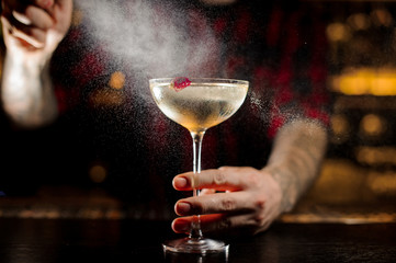 Bartender spraying on a Twinkle cocktail in the bar