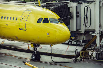 Obraz premium Aircraft on the gate in the airport waiting for passengers for flight.