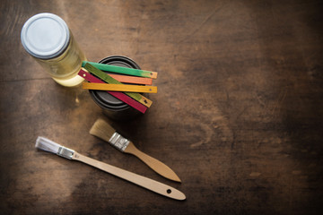 Creativity. Color samples on paint can. Color samples, paint, solvent and brush on an old wooden...