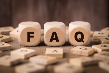 FAQ Sign With Wooden Background
