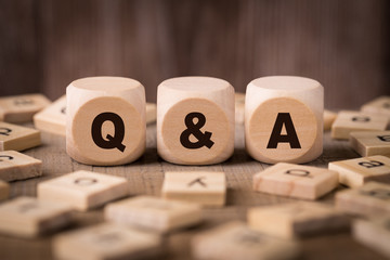 Q A Sign With Wooden Background