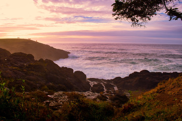 Ocean waves crashing onto the rocks in the sunset © CK
