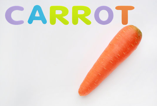 Carrot isolated on the white background with sponge rubber of text "CARROT"