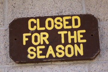 A wooden sign that states "Closed For the Season"