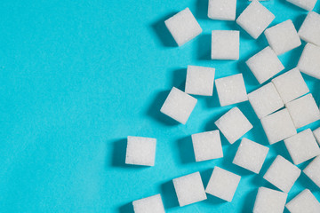 Table top shot Group of Sugar cubes vary position on light blue background