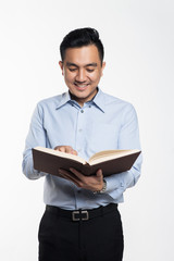 Asian man reading book looking for answer