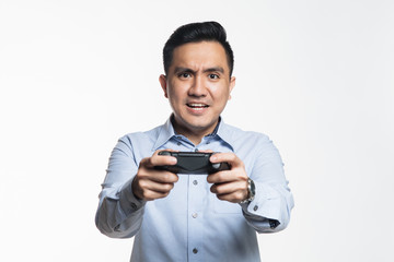 Asian man in work cloth playing console game