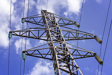 Industrial Scenery: Electric High Voltage Pylon on Blue Sky Background - 231104871
