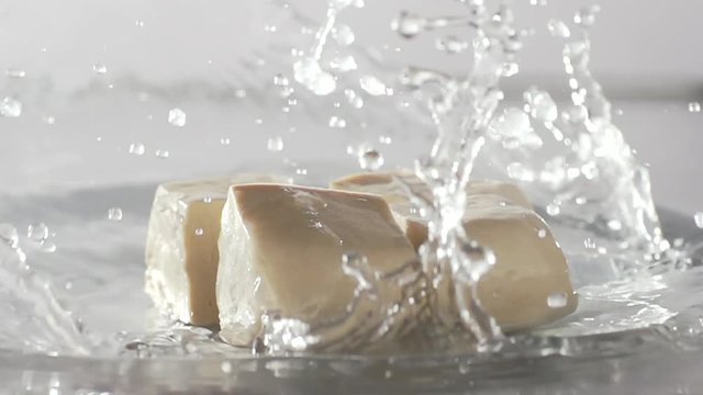 View footage slow motion tofu falling and water splash out