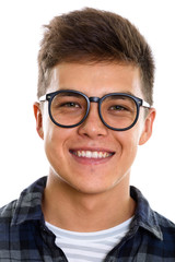 Face of young happy man smiling with eyeglasses