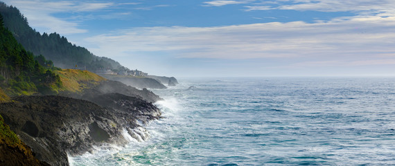 Ocean waves crashing onto the rocks in the sunset