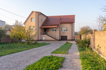 Fototapeta na wymiar Big custom made luxury house with nicely landscaped front yard , Ukraine