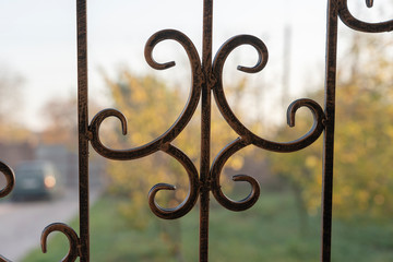 Black metal fence, close up. Beautiful decorative cast iron wrought fence with artistic forging