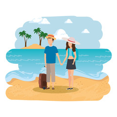 young couple with suitcase on the beach