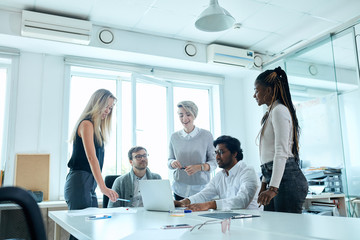 corporate executive team in the meeting. young people discussing business project in friendly...