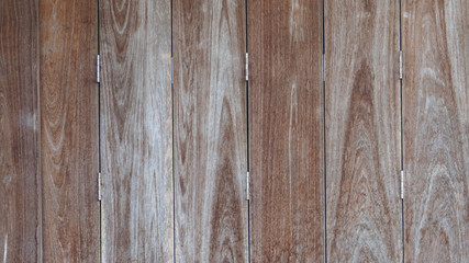 Wooden texture of vintage folding door is close brown color tone background