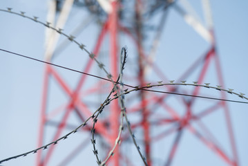 Barbed wire fence. Observation tower in the background