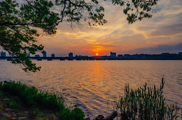 Sunset over Charles River with skyline of Cambridge, in Boston, USA