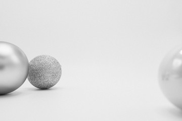 Silver, white and glittered monochrome Christmas baubles.