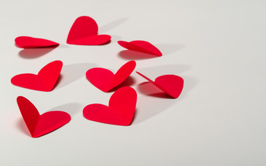 red paper hearts on white background