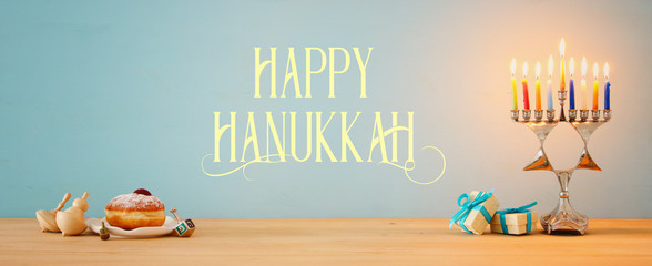 Banner of jewish holiday Hanukkah background with traditional spinnig top, menorah (traditional...