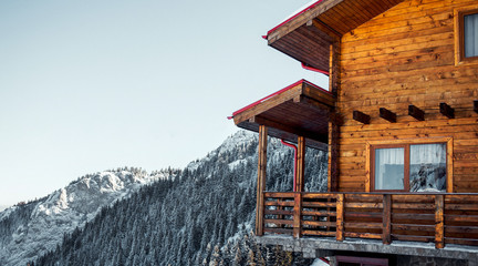 Winter vacation holiday alpine wooden house skiing relax leisure resort in the mountains covered...
