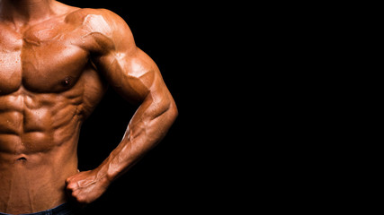 Fototapeta na wymiar Muscular shape male torso on black background.
