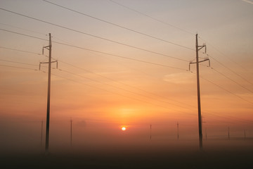 Fototapeta na wymiar Power line in fog in the early morning