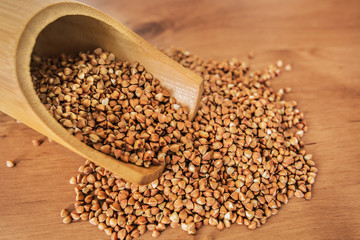 Buckwheat grains on wooden background