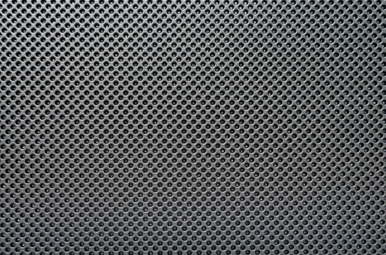 Black modern textured plastic structure, with small circles. Image for abstract technology background.