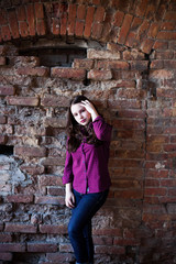 Fototapeta na wymiar girl in plaid shirt posing against the wall