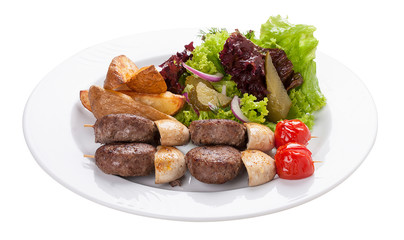 Set of kebabs with vegetable garnish on a white plate