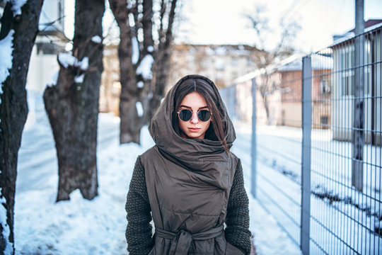 Pretty girl walking outdoor on the street, winter time.