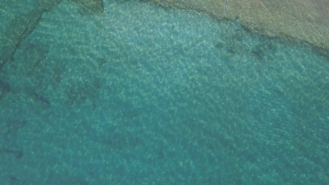 Aerial view of water reflections on the sea. Transparent water