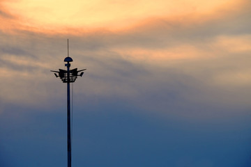 Silhouette of sphere lamp pole over the sun during sunset in landscape orientation