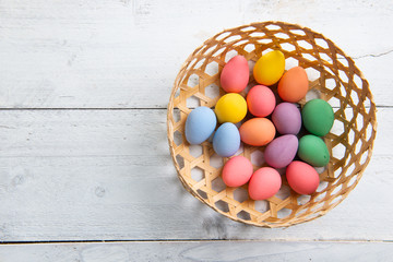 Colored easter eggs on white wooden