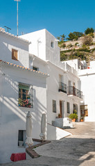 Fototapeta na wymiar Street of white walls in a village of Andalusia called Frigiliana