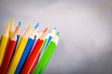 Pencils colorul color wooden pencil in metal holder in front of wall background