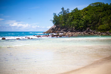 Landscape photo of beautiful white sand exotic beach on Mahe island in Seychelles