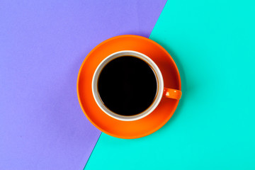 cup of coffee and saucer on color background